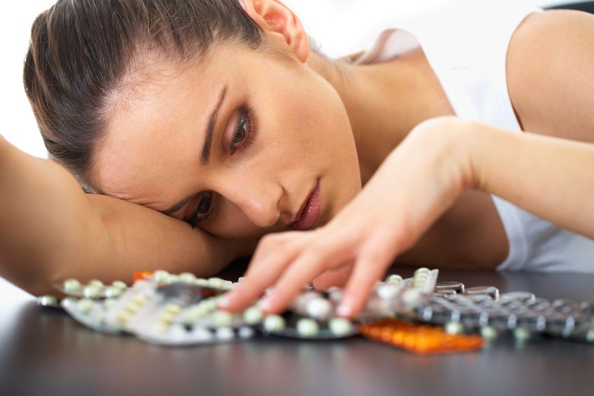 woman counting pills